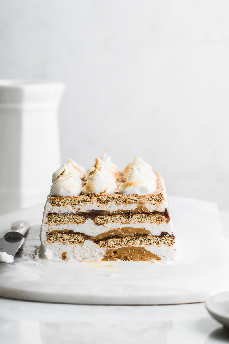 icebox cake layered with peanut butter on grey and white background