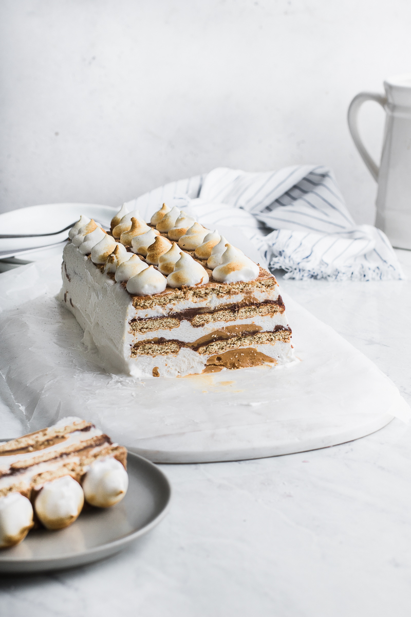 icebox cake with toasted topping on grey and white background