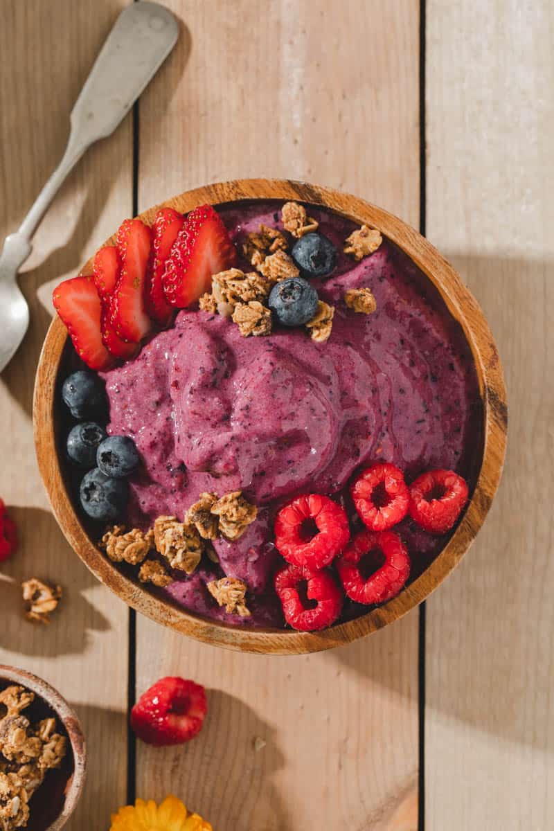 Homemade vegan plant based mixed berry smoothie bowl.