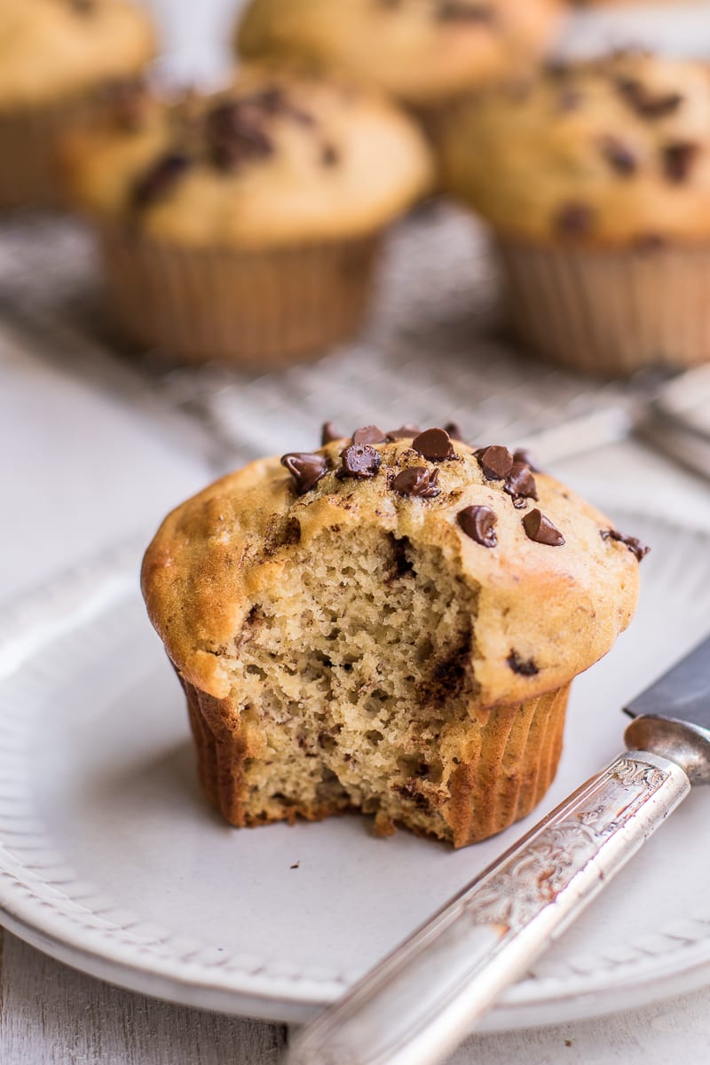 healthy banana chocolate chip muffins with a giant bite taken out.