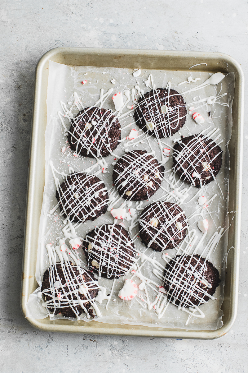 pan of chocolate peppermint cookies topped with white chocolate drizzle. Food photography