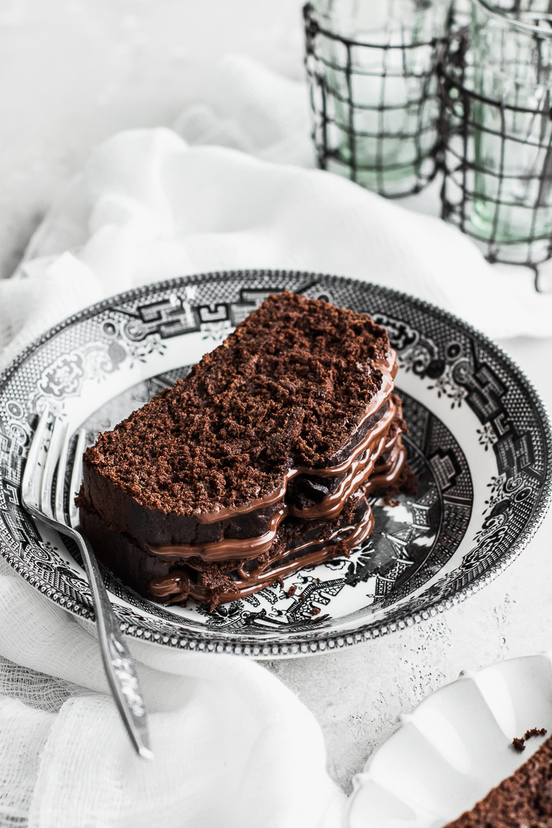 chocolate cake on a black and white plate