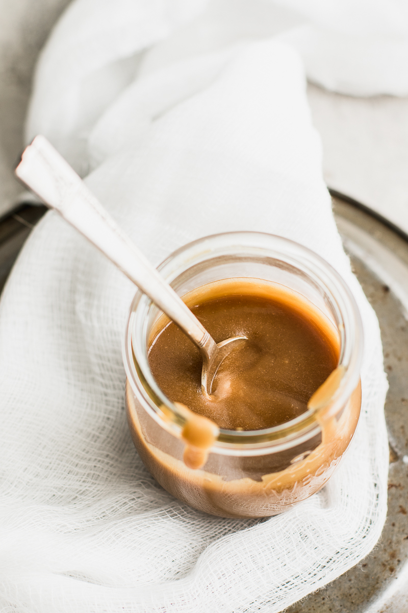 caramel sauce with a spoon in a jar