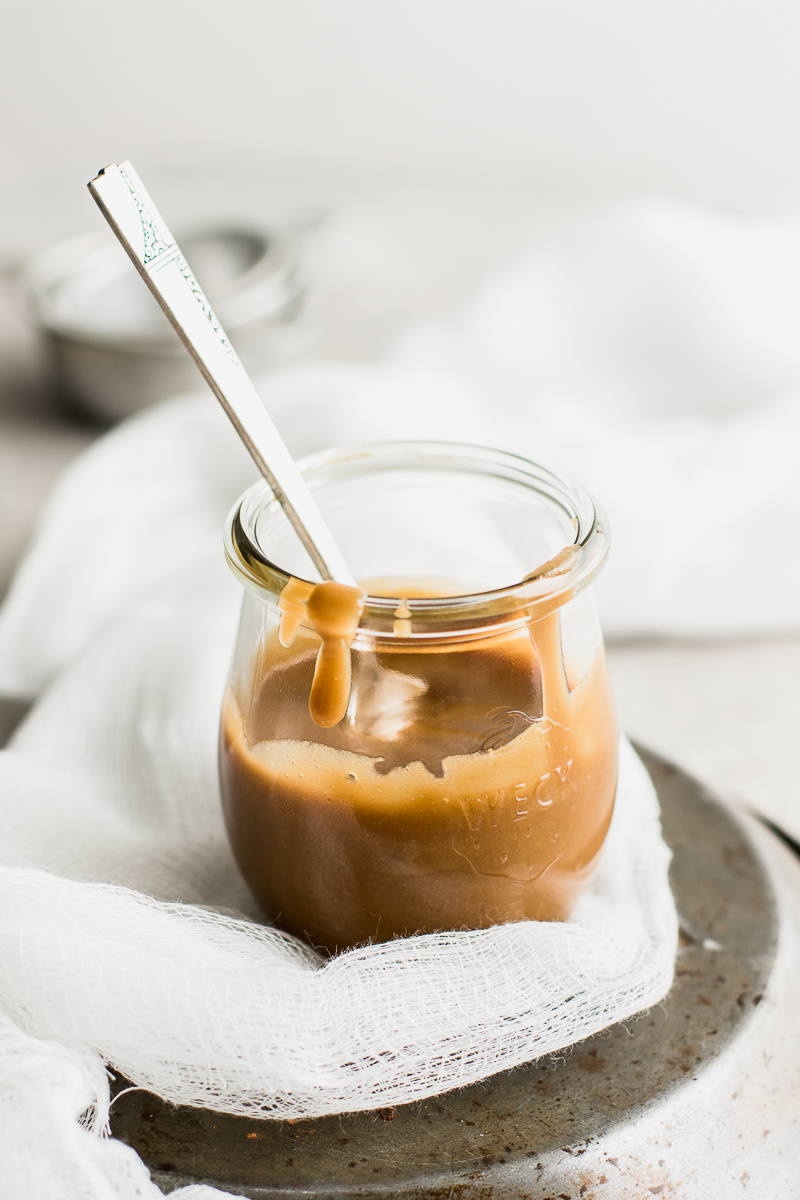 vegan caramel sauce in a jar with spoon