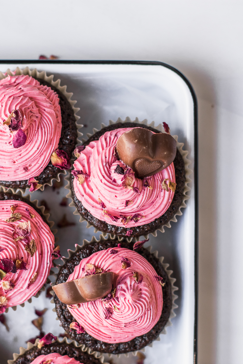 Chocolate cupcakes with strawberry frosting and rose petals. Valentine's cupcakes