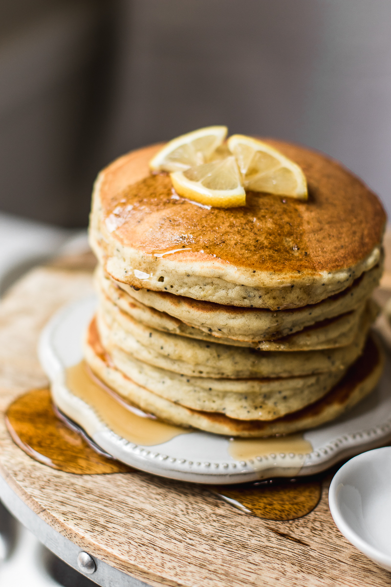 Lemon Poppy Seed Pancakes drizzled with maple syrup.