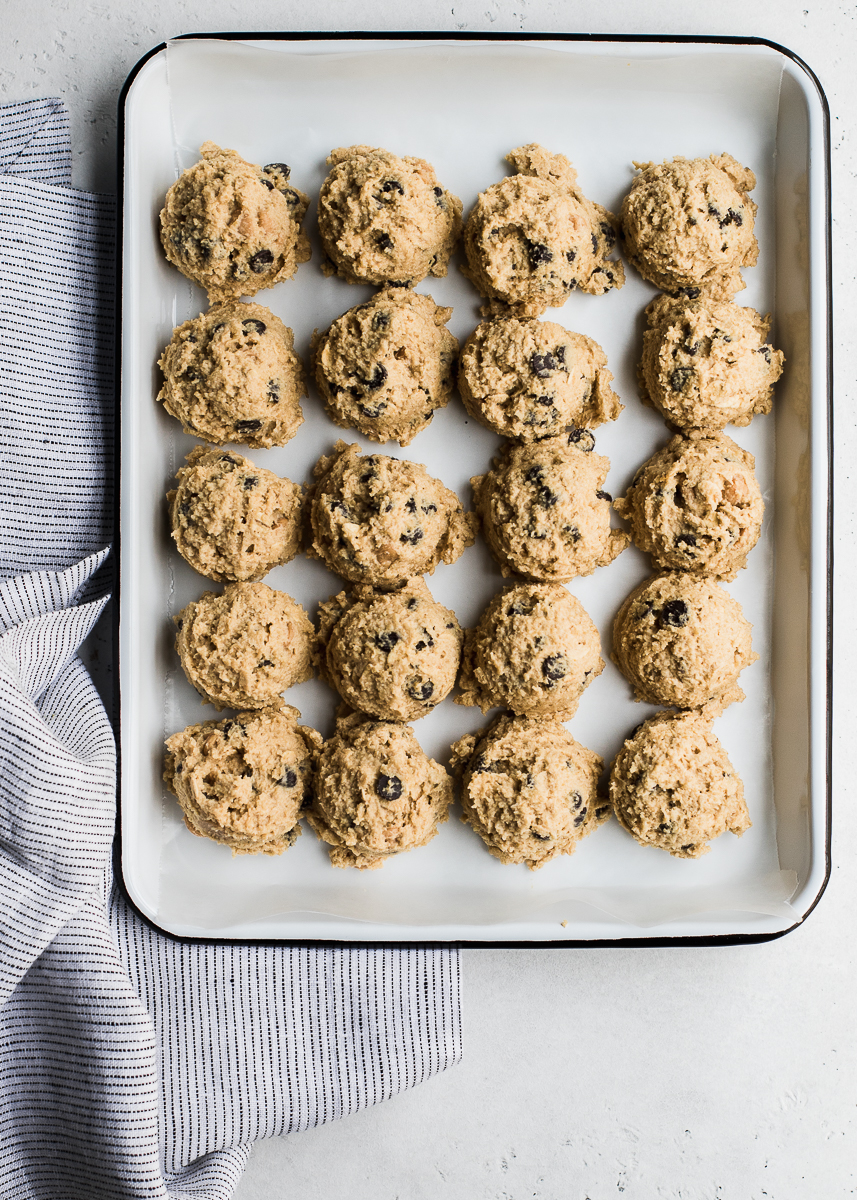 chocolate chunk cookie dough balls lined in a white tray