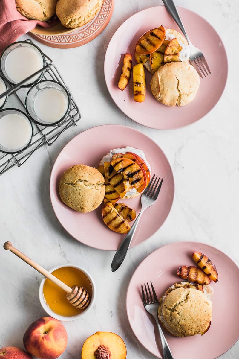 grilled peaches and shortcakes on pink plates 