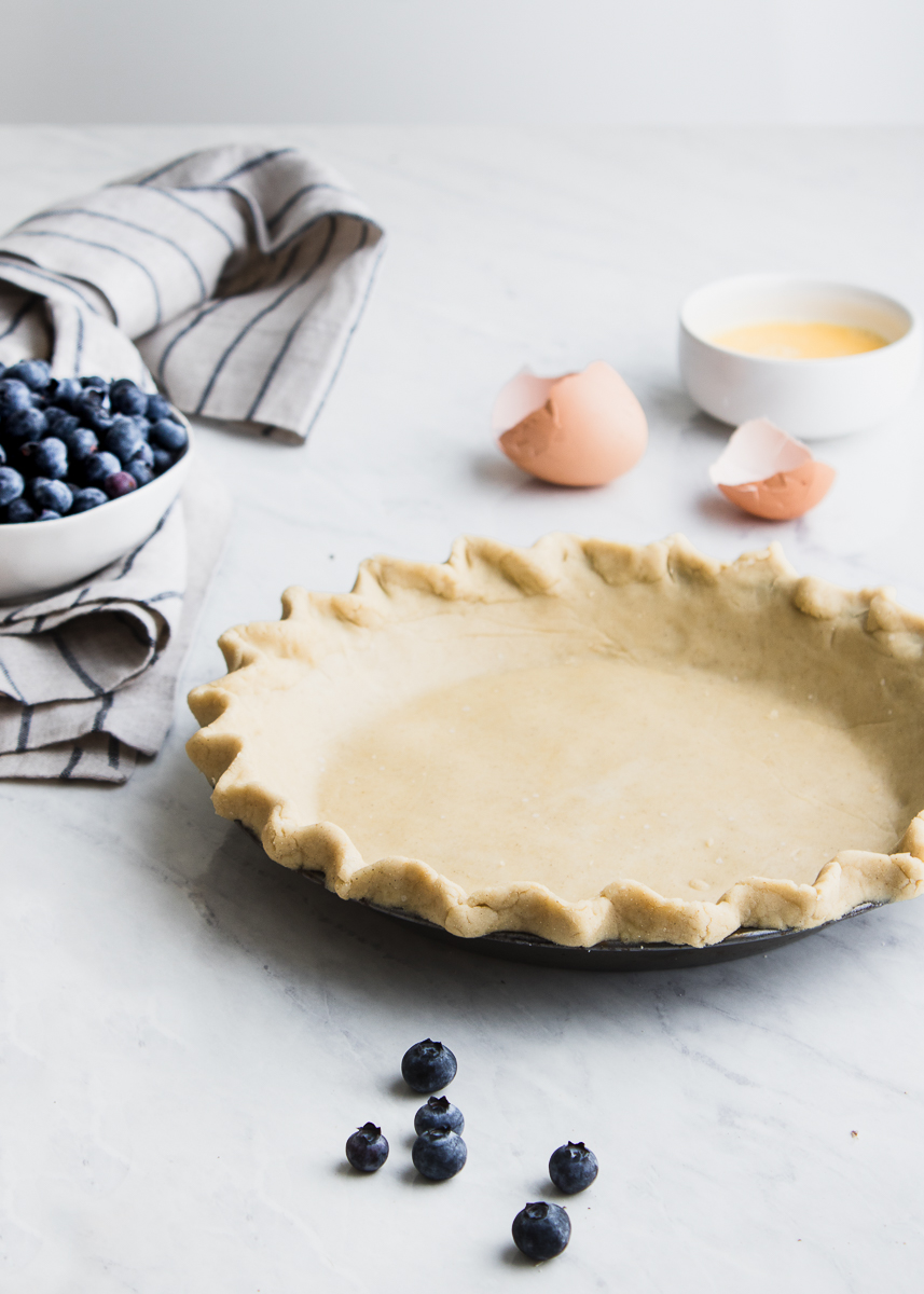 pie crust with egg shells and blueberries