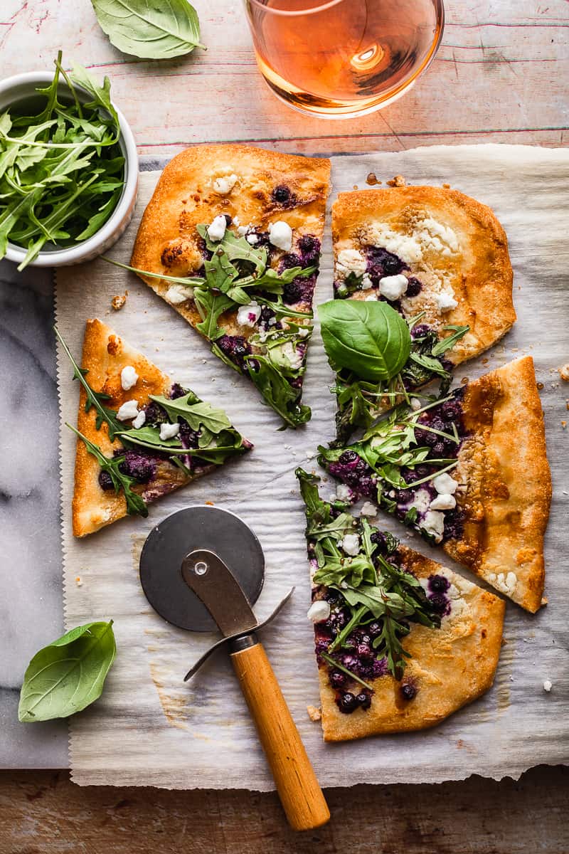Gluten free goat cheese pizza with wild blueberries. Amazing dairy free recipes. Delicious gluten free pizza.