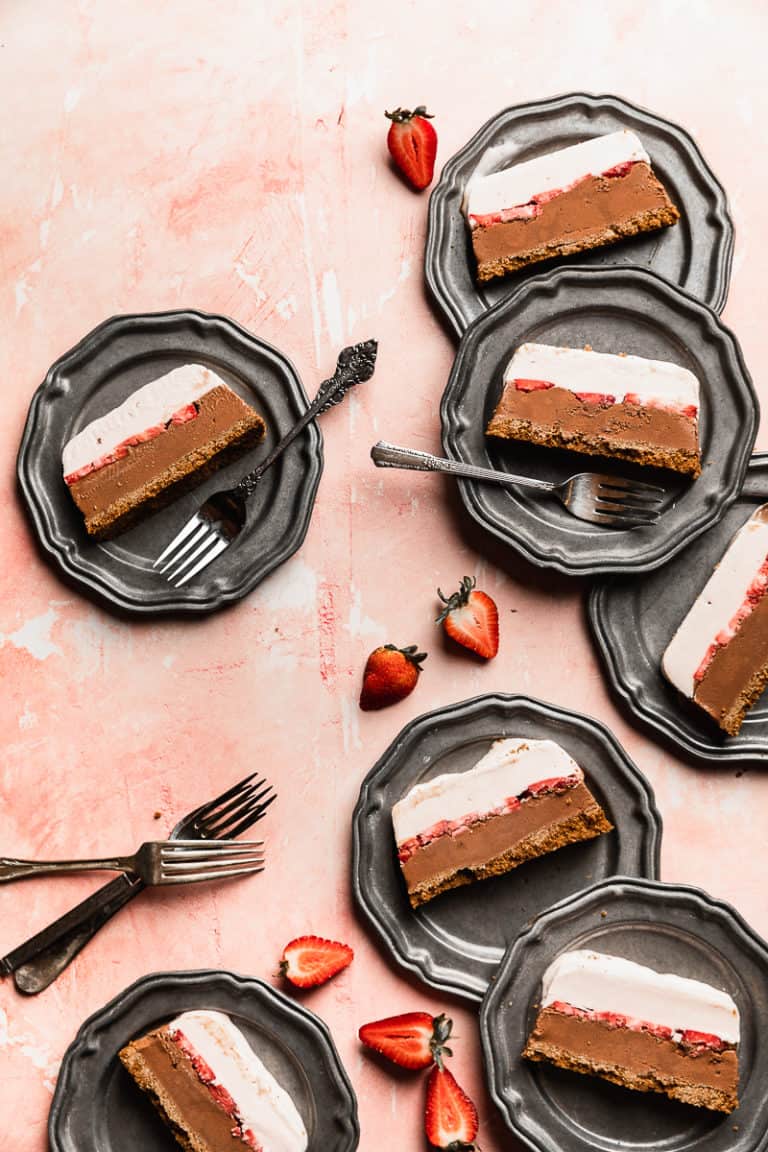 dairy free ice cream cake layers on plates and pink surface