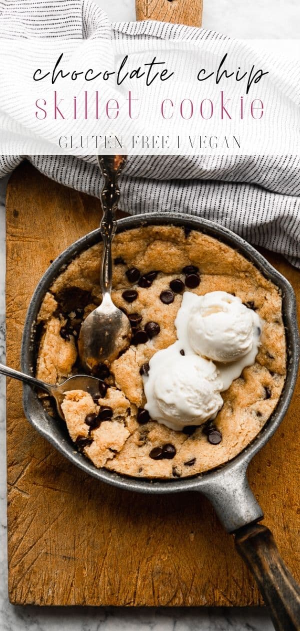 Two spoons digging into a skillet cookie.