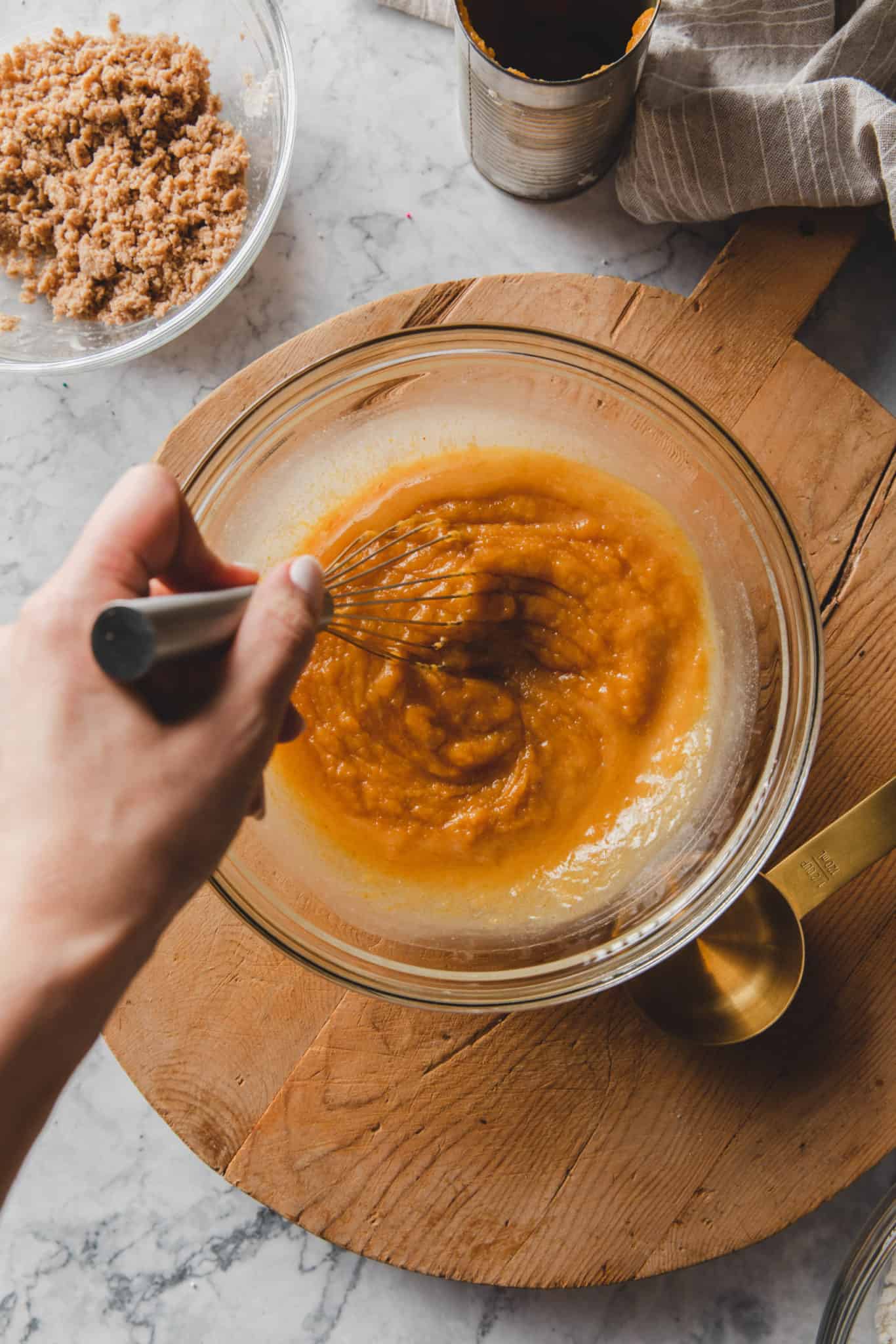 whisking together the wet ingredients  for a vegan pumpkin muffin recipe