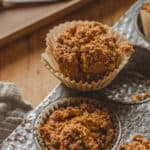 A batch of homemade pumpkin muffin recipe with streusel crumble topping.