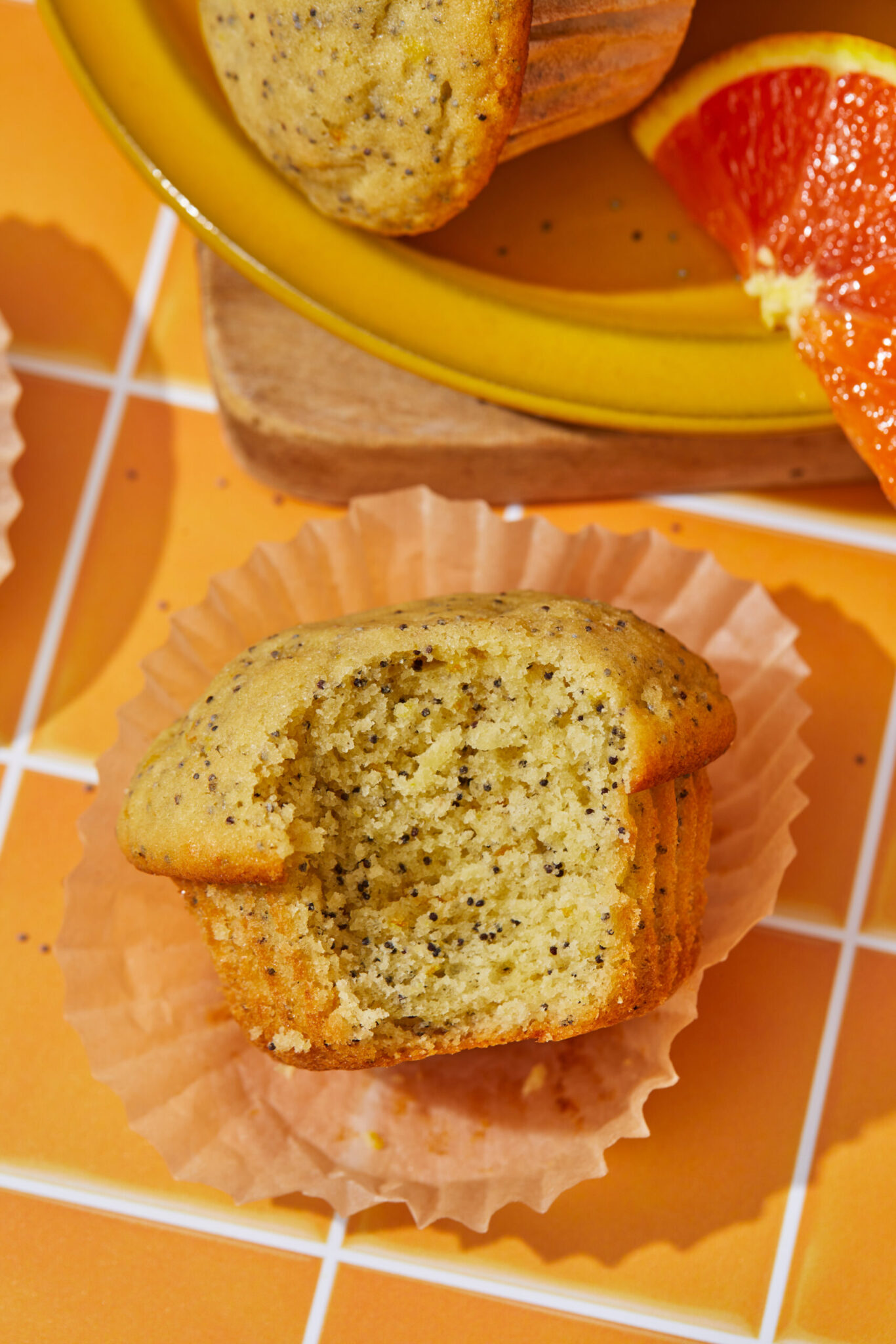 orange and poppy seed muffins with a bite taken out
